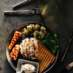 Food Aesthetics - A gourmet dish featuring grilled salmon, rice, g #10506640