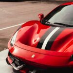 Luxury Cars - A gleaming red Ferrari with black stripes displa #10889192