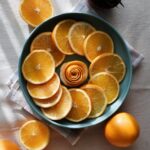 Food Aesthetics - Vibrant flatlay of orange slices in a ceramic bo #14692500