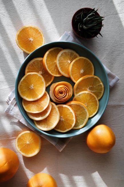 Food Aesthetics - Vibrant flatlay of orange slices in a ceramic bo #14692500