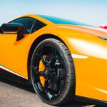 Luxury Cars - Close-up of a vibrant yellow luxury supercar on  #14843602