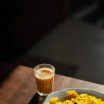 Food Aesthetics - A glass of coffee alongside a plate of vibrant y #16100369