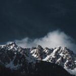 Mountain Landscapes - Stunning snowy mountain peaks under a dramatic d #16530781