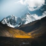 Mountain Landscapes - Stunning snowy peaks and a yellow meadow under a #18046508