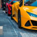 Luxury Cars - Yellow and red luxury sports cars parked on urba #18187178