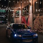 Luxury Cars - Blue Nissan Skyline R34 GTR in urban alley with  #19163276