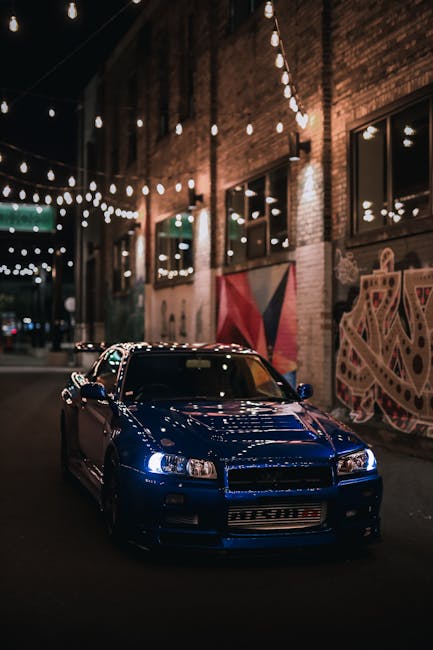Luxury Cars - Blue Nissan Skyline R34 GTR in urban alley with  #19163276