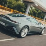 Luxury Cars - Sleek Aston Martin Vantage zooming on a highway  #19986973