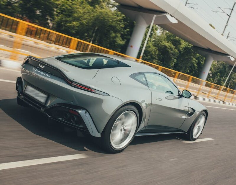 Luxury Cars - Sleek Aston Martin Vantage zooming on a highway  #19986973