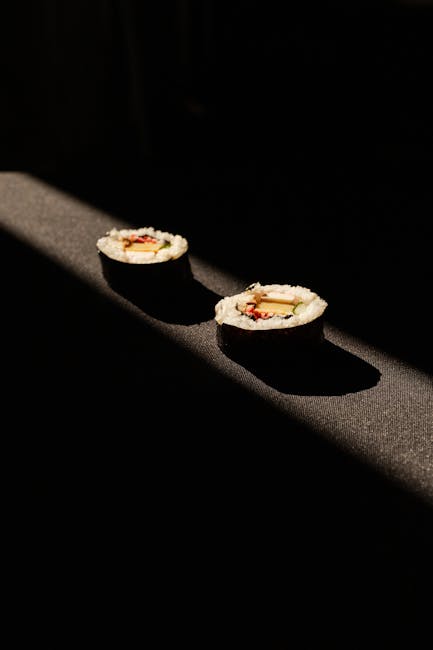 Food Aesthetics - Artistic shot of two sushi rolls under dramatic  #31263153