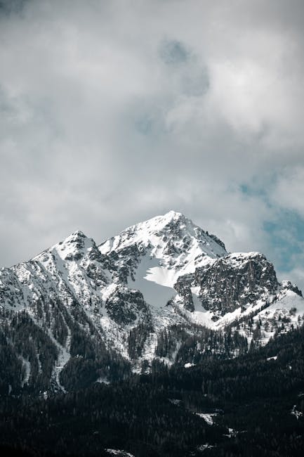 Mountain Landscapes - Majestic snow-covered mountain peaks under cloud #31299675