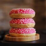 Food Aesthetics - Three pink frosted donuts with sprinkles stacked #31481575