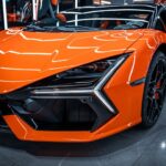 Luxury Cars - Vibrant orange sports car with elegant design in #34054723