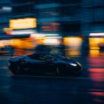 Luxury Cars - A sleek black sports car zooms through a vibrant #35319488