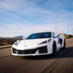 Luxury Cars - White sports car cruising on a scenic highway in #36279216