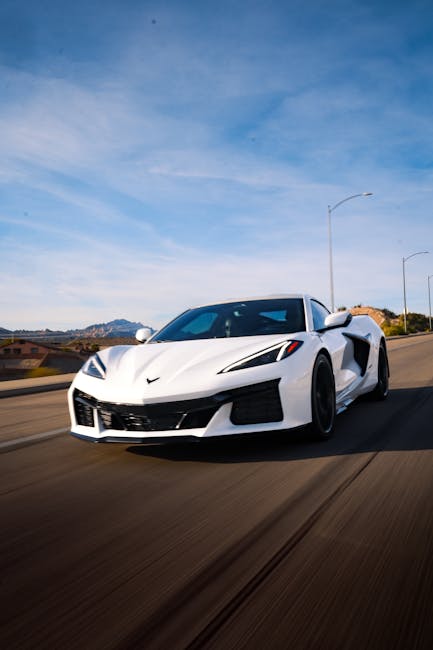 Luxury Cars - White sports car cruising on a scenic highway in #36279216