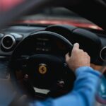 Luxury Cars - Close-up of a person driving a red luxury sports #36597202