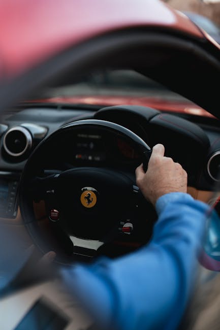 Luxury Cars - Close-up of a person driving a red luxury sports #36597202