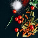 Food Aesthetics - Flatlay of uncooked pasta, cherry tomatoes, and  #5794880