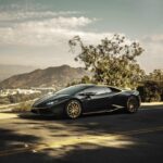 Luxury Cars - A sleek luxury sports car parked on a scenic roa #6601345