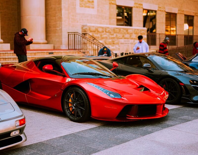 Luxury Cars - A lineup of luxury sports cars parked on an urba #7537128