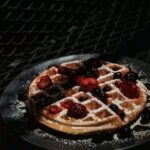 Food Aesthetics - Dark moody shot of a waffle topped with fresh be #8178424